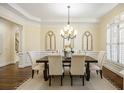 Dining room with a wooden table set for six and beautiful views at 1734 Doonbeg Ct, Kennesaw, GA 30152