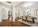 Bright dining room featuring hardwood floors, chandelier lighting, and classic architectural details at 1734 Doonbeg Ct, Kennesaw, GA 30152