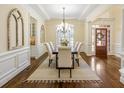 Open-concept dining room featuring elegant furnishings, hardwood floors, and natural light at 1734 Doonbeg Ct, Kennesaw, GA 30152