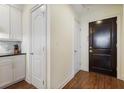 Hallway featuring hardwood floors and doors leading to various rooms with modern finishes at 2828 Peachtree Nw Rd # 903, Atlanta, GA 30305