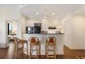 Bright kitchen with modern black appliances, breakfast bar, pendant lighting and an open floor plan at 2828 Peachtree Nw Rd # 903, Atlanta, GA 30305