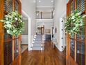Grand foyer with hardwood floors, a staircase, and an open view to the upper level at 3576 Sexton Woods Dr, Chamblee, GA 30341