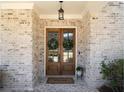 Elegant double front doors adorned with wreaths, set within a charming brick facade at 3576 Sexton Woods Dr, Chamblee, GA 30341