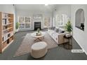 Bright living room featuring a fireplace, plush seating, and large windows providing abundant natural light at 4540 Flat Willow Pl, Douglasville, GA 30135
