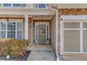 Inviting front entrance with a decorative wreath, stone accents, and a well-lit porch at 1169 Harvest Brook Dr, Lawrenceville, GA 30043