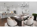 Open-concept kitchen and dining area with modern lighting and stainless-steel appliances at 2140 Parkside Ln, Roswell, GA 30076