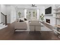 Bright living room with hardwood floors, fireplace, and large windows at 2140 Parkside Ln, Roswell, GA 30076