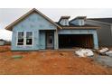 View of the exterior of a new construction house with exposed weather resistant barrier and an attached garage at 2040 Ripple Park Bend, Canton, GA 30114
