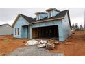 New construction house with exposed weather resistant barrier and garage in an unfinished lot at 2040 Ripple Park Bend, Canton, GA 30114
