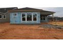 Back of a new construction house with exposed weather resistant barrier and windows at 2040 Ripple Park Bend, Canton, GA 30114