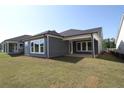 Spacious backyard features a covered patio perfect for outdoor entertaining or relaxation at 2040 Ripple Park Bnd, Canton, GA 30114