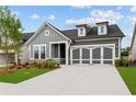 Charming single-Gathering home with a two-car garage, manicured lawn, and stone accents at 2040 Ripple Park Bnd, Canton, GA 30114
