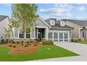 Charming single-Gathering home with a two-car garage, manicured lawn, and stone accents at 2040 Ripple Park Bnd, Canton, GA 30114