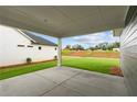 A covered patio provides a comfortable outdoor living space and view of the yard at 2040 Ripple Park Bnd, Canton, GA 30114