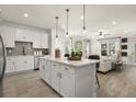 Open-concept kitchen with white cabinets, a large center island, and stainless steel appliances at 208 Bastian Dr # 108, Villa Rica, GA 30180