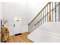 Light-filled foyer with hardwood floors, staircase with wrought iron spindles, and elegant trim detail at 4758 Sultana Way, Atlanta, GA 30331