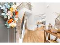 Bright entryway showcasing hardwood floors, high ceilings, elegant staircase, and a view to a modern kitchen at 4758 Sultana Way, Atlanta, GA 30331