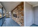 The front porch features stacked stone accents and painted wood flooring at 218 Pine Needle Trl, Villa Rica, GA 30180