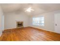 Bright living room features hardwood floors, stone fireplace and large windows at 218 Pine Needle Trl, Villa Rica, GA 30180