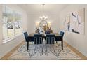 Elegant dining area with modern lighting, a large window, and chic decor, perfect for entertaining at 2201 Cormac St, East Point, GA 30344