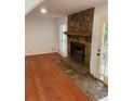 Living room featuring a stone fireplace and hardwood floors at 1173 Mill Ridge Dr, Lawrenceville, GA 30045