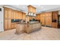 Gourmet kitchen with custom wood cabinetry, a large island, and top-of-the-line stainless steel appliances at 8480 St Marlo Fairway, Duluth, GA 30097