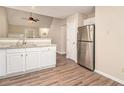 Kitchen featuring stainless steel refrigerator, granite countertops, and wood grain floors at 132 Prity Ct, Mcdonough, GA 30253