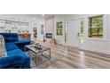Open-concept living area with modern finishes, an electric fireplace, and seamless flow to kitchen at 1400 Bouldercrest Rd, Atlanta, GA 30316