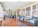 Charming front porch with hardwood floors, comfortable seating, and views of the neighborhood at 1518 Cambridge Ave, Atlanta, GA 30337