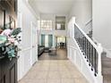 Inviting foyer features high ceilings, tile flooring, staircase, and views into the living and dining areas at 2304 Stancrest Ln, Lawrenceville, GA 30044