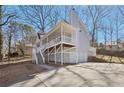 Exterior side elevation of home showcasing spacious driveway, porch, and two-car garage at 100 Nottingham Dr, Douglasville, GA 30134