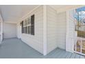 Covered porch featuring gray painted wood flooring and complementing gray exterior at 100 Nottingham Dr, Douglasville, GA 30134