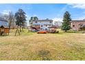 Expansive backyard with a large lawn, deck, gazebo, and mature trees at 1710 Meadowchase Ct, Snellville, GA 30078