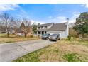 Two-story home with a long driveway, a charming porch, and a two-car attached garage at 1710 Meadowchase Ct, Snellville, GA 30078