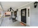 Inviting covered front porch with rocking chairs, a swing, and decorative lanterns at 1710 Meadowchase Ct, Snellville, GA 30078