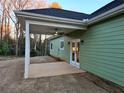 Relaxing covered porch with ceiling fan, white columns, and access to the home through elegant French doors at 6022 Fieldcrest Dr, Morrow, GA 30260