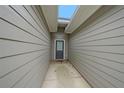 A back entrance featuring a door with a window panel, siding, and narrow passageway for entry at 92 Fairview Oak Trce, Dallas, GA 30157