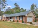 Beautiful brick home featuring an attached garage and manicured landscaping at 1605 Mcgarity Rd, Mcdonough, GA 30252