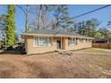 This charming single-story home has a welcoming front yard and a practical, accessible design at 1932 Rosewood Rd, Decatur, GA 30032