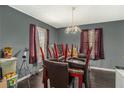 Bright dining room with a chandelier and large windows overlooking a fenced backyard at 69 Polar Rock Sw Rd, Atlanta, GA 30315