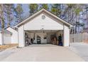 Spacious three car garage with organized shelving units and overhead lighting at 975 Fox Valley Trl, Stone Mountain, GA 30088