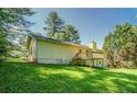 Exterior view of a yellow home, highlighting a well-maintained backyard with a small wooden deck at 2811 Bay Leaf Se Dr, Conyers, GA 30094