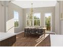 Dining room featuring a classic wooden table and chair set next to large windows at 6206 Cedarcrest Nw Rd, Acworth, GA 30101