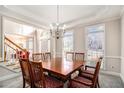 Elegant dining room with a large table, chandelier, and natural light at 3735 Holiday Lane Ln, Atlanta, GA 30349