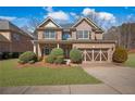 Beautiful two-story brick home features a well-maintained lawn and an attached two-car garage at 1502 Park Hollow Ln, Lawrenceville, GA 30043