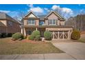 Beautiful two-story brick home features a well-maintained lawn and an attached two-car garage at 1502 Park Hollow Ln, Lawrenceville, GA 30043