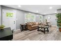 Open-concept living room with wood-look floors, neutral walls, and comfortable seating, perfect for relaxation and entertaining at 2150 Meadowlane Dr, Atlanta, GA 30311