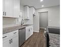 The kitchen features a stainless steel dishwasher, granite countertops, and modern white cabinetry at 2478 Graywall St, Atlanta, GA 30344