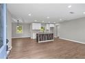 Open-concept kitchen featuring modern white cabinetry, granite countertops, and a rustic center island at 2478 Graywall St, Atlanta, GA 30344