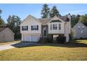 Traditional two-story home with a neat front lawn, showcasing curb appeal and a welcoming entrance at 2733 Cedar Tree Ln, Ellenwood, GA 30294